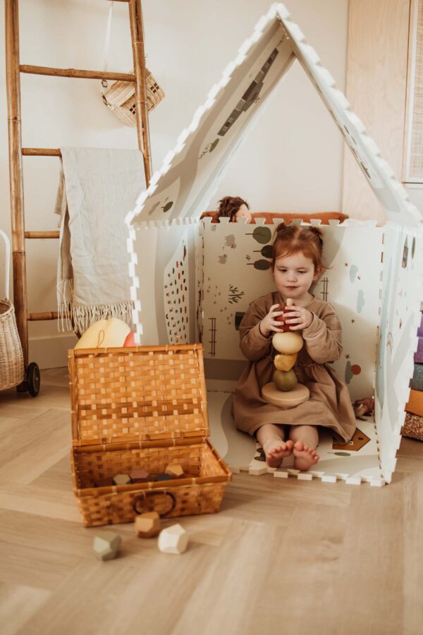 PlayandGo_EEVAA_farm_puzzlemat_made_in_a_playhouse_child_is_sitting_inside_while_playing_with_wooden_toys_wooden_basket